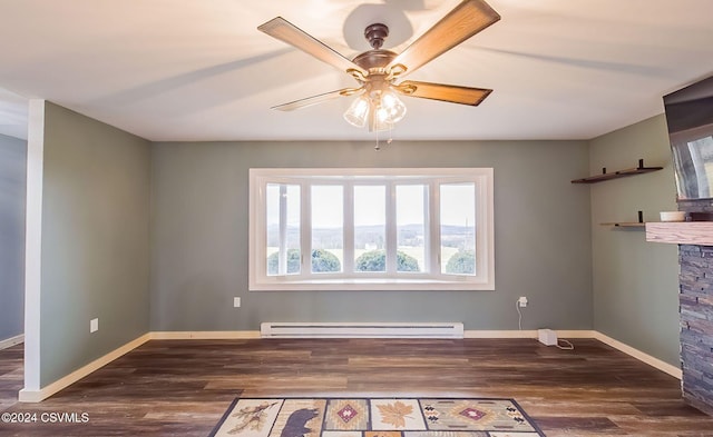 unfurnished room with ceiling fan, a stone fireplace, dark wood-type flooring, and a baseboard heating unit