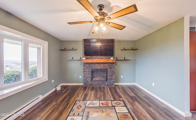 unfurnished living room featuring a fireplace, a baseboard radiator, ceiling fan, and dark wood-type flooring