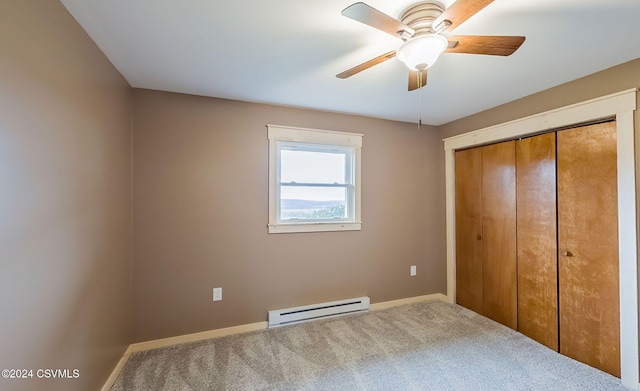 unfurnished bedroom featuring carpet flooring, a closet, a baseboard radiator, and ceiling fan