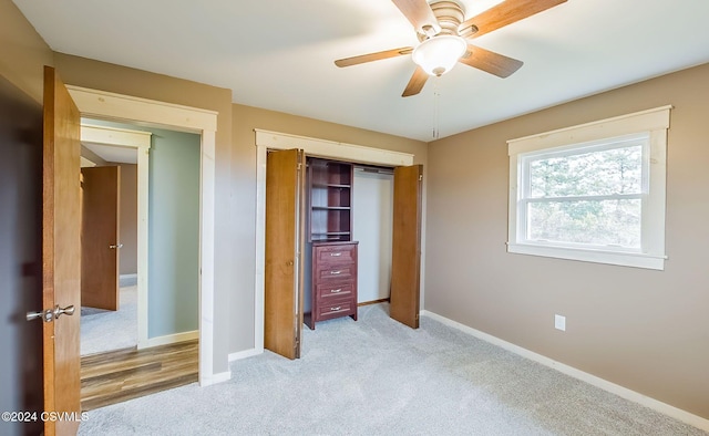 unfurnished bedroom featuring ceiling fan, light carpet, and a closet