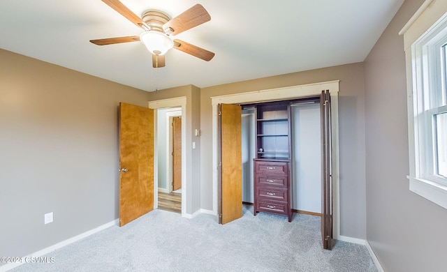 bedroom featuring multiple windows, ceiling fan, and light carpet