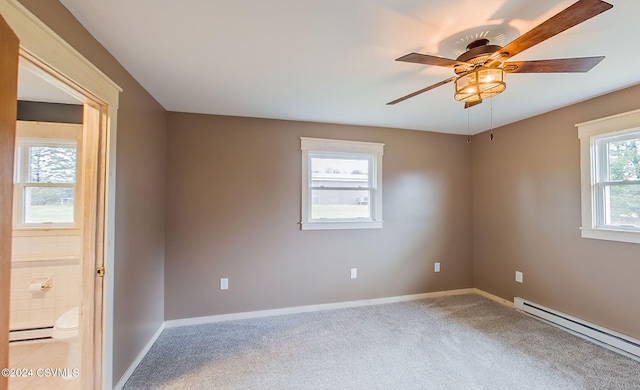 spare room with light carpet, baseboard heating, and ceiling fan