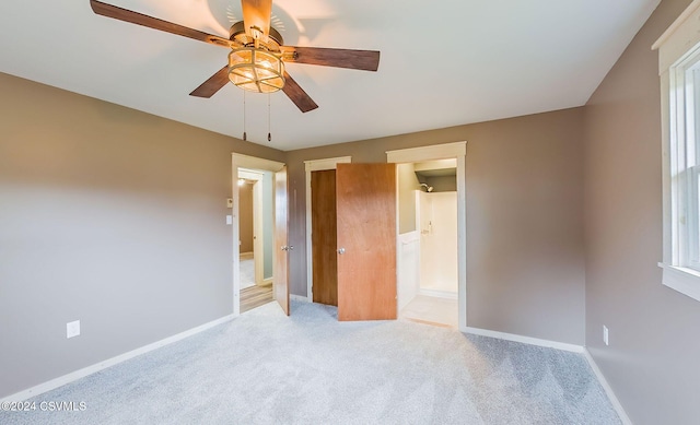 unfurnished bedroom featuring ceiling fan and light colored carpet