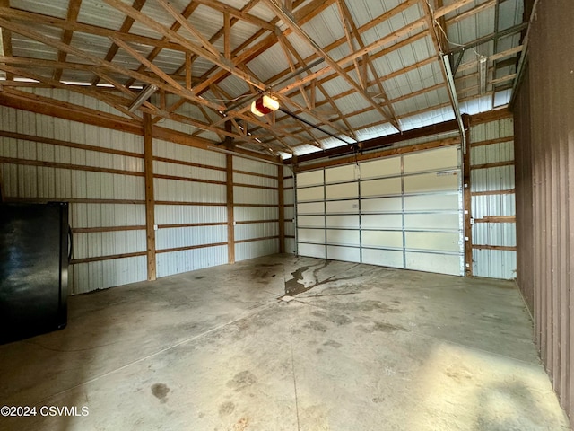 garage with black fridge and a garage door opener