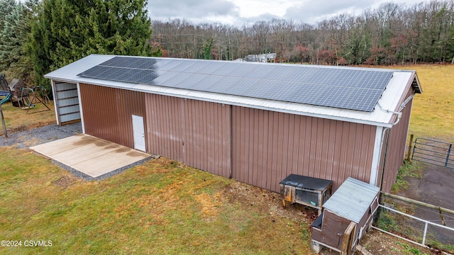 view of outdoor structure featuring solar panels