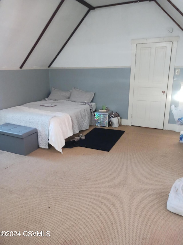 carpeted bedroom featuring lofted ceiling