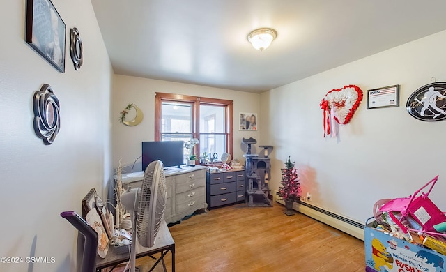 office area featuring light hardwood / wood-style floors and a baseboard heating unit