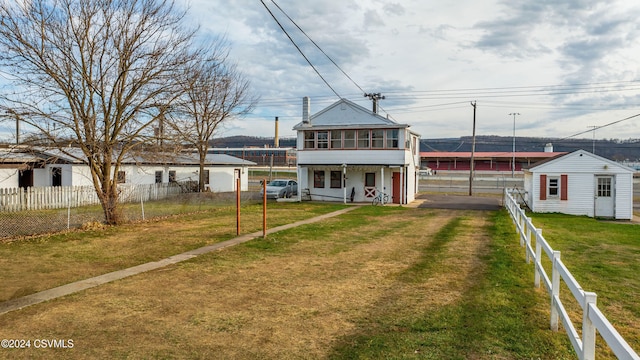 rear view of property with a yard