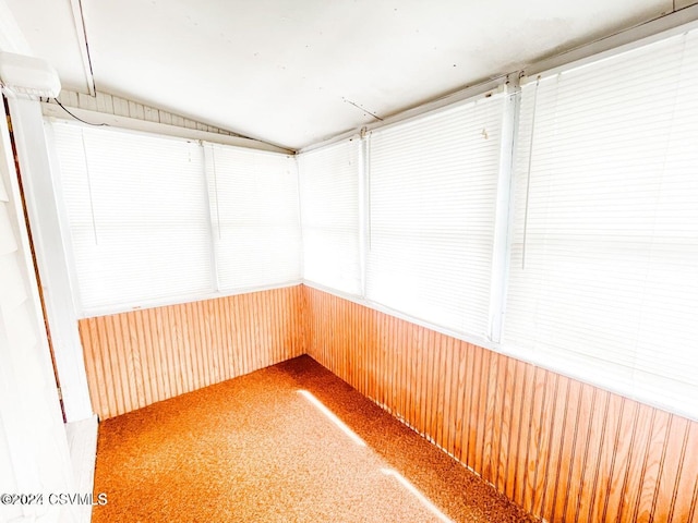 unfurnished sunroom with lofted ceiling