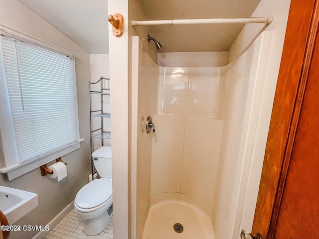 bathroom featuring toilet, tile patterned floors, and walk in shower