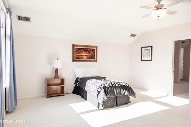 bedroom featuring light carpet, vaulted ceiling, and ceiling fan