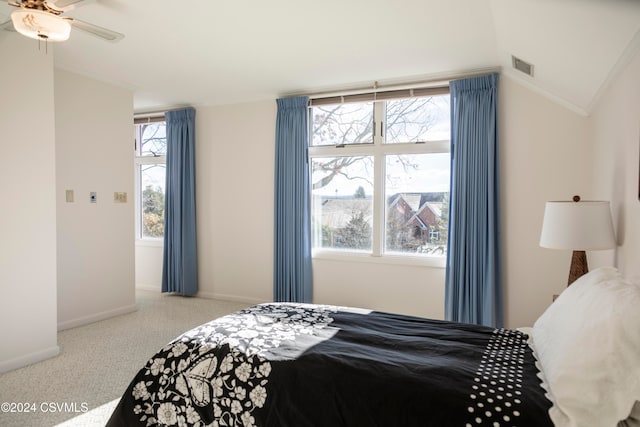 carpeted bedroom featuring multiple windows, ceiling fan, and lofted ceiling