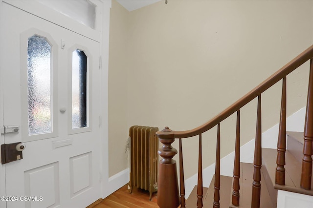 entrance foyer featuring radiator heating unit and light wood-type flooring