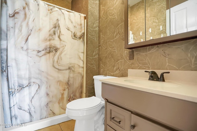 bathroom featuring tile patterned floors, vanity, and toilet