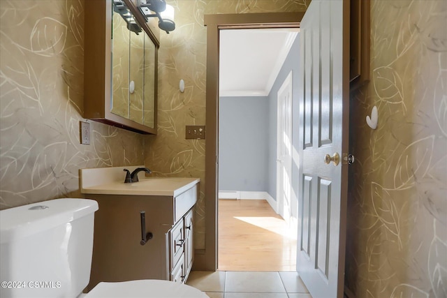 bathroom featuring vanity, crown molding, a baseboard radiator, hardwood / wood-style flooring, and toilet