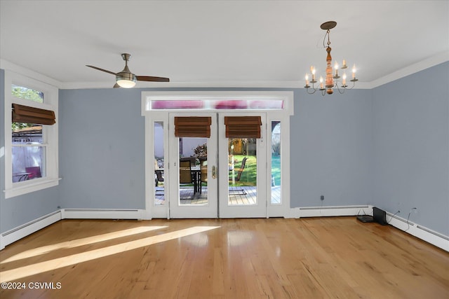 empty room with french doors, ceiling fan with notable chandelier, light hardwood / wood-style floors, and crown molding