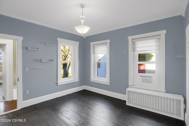 unfurnished room featuring radiator heating unit, dark hardwood / wood-style floors, and cooling unit