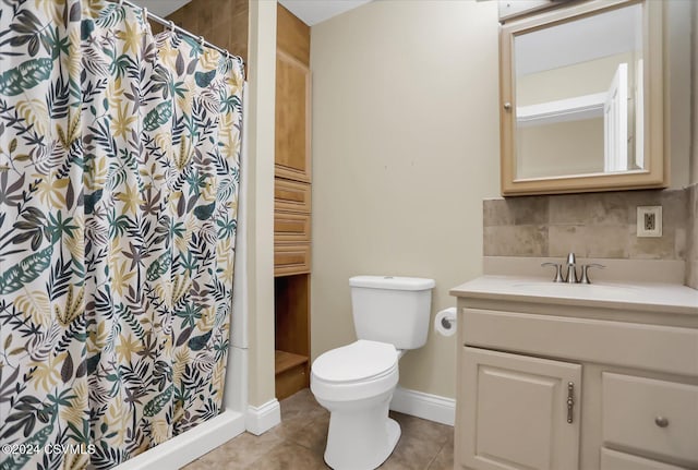 bathroom with vanity, backsplash, tile patterned floors, toilet, and walk in shower