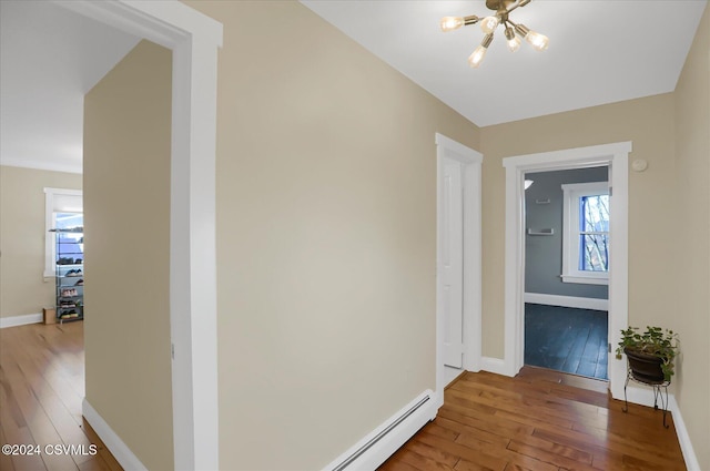 hall with an inviting chandelier and hardwood / wood-style flooring