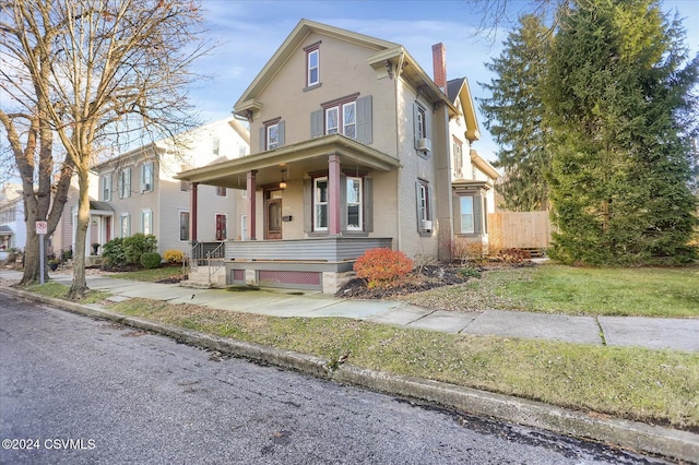 view of front of house with a porch and a front lawn