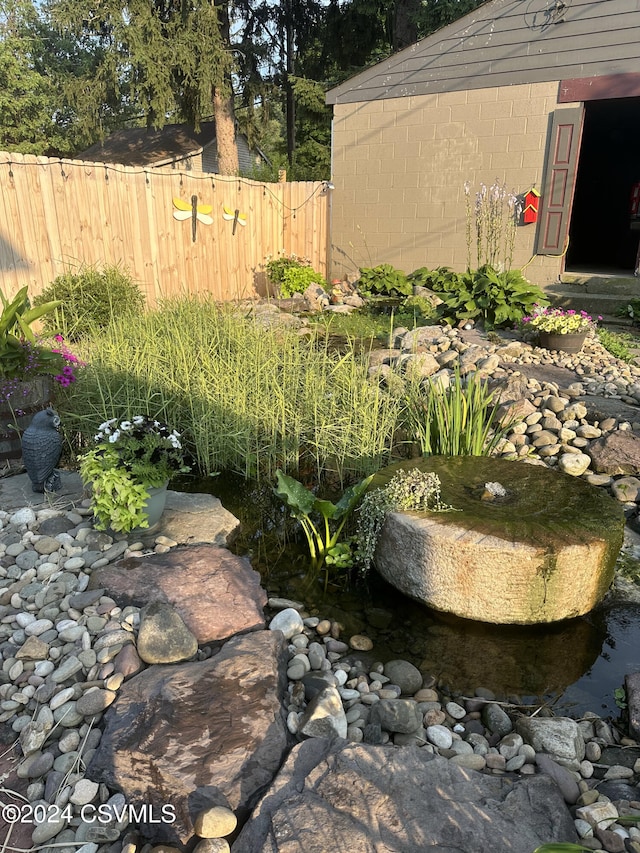 view of yard featuring a small pond