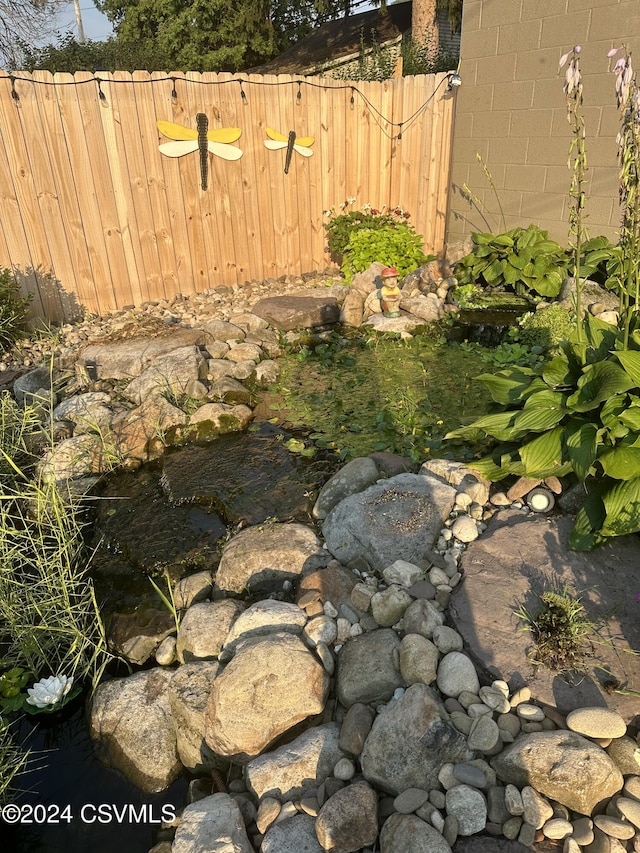 view of yard with a garden pond