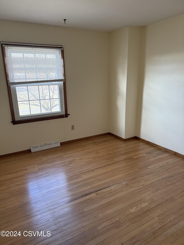 spare room with light hardwood / wood-style flooring and a baseboard radiator