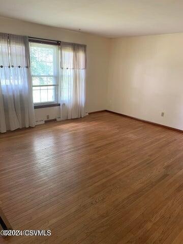 unfurnished room featuring dark hardwood / wood-style floors