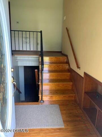 stairs with hardwood / wood-style floors