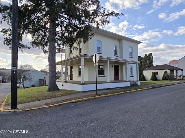 view of front of property with a front lawn and covered porch