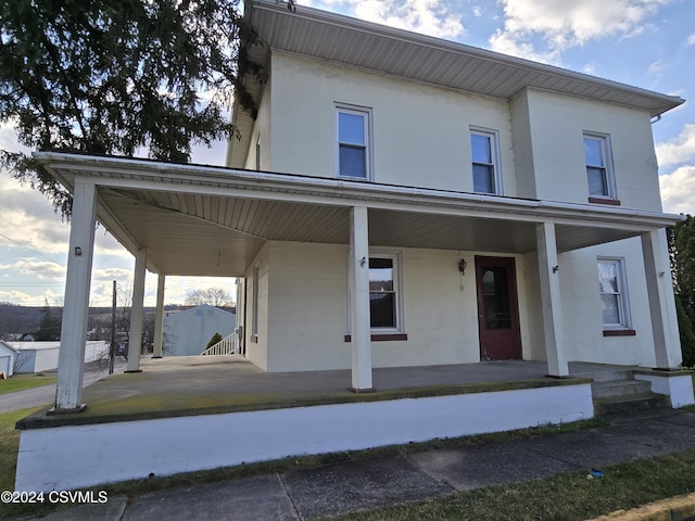 524 Front St, New Berlin, PA 17855 - view of front facade featuring a porch and stucco siding
