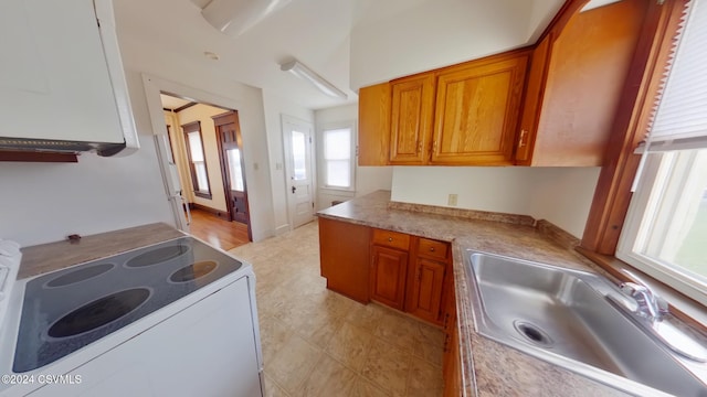 kitchen with electric stove and sink