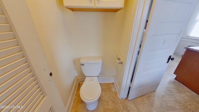 bathroom with tile patterned flooring, vanity, and toilet