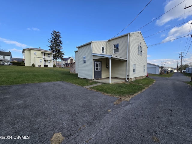 view of home's exterior featuring a lawn and a garage