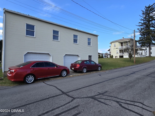 exterior space featuring a front yard and a garage