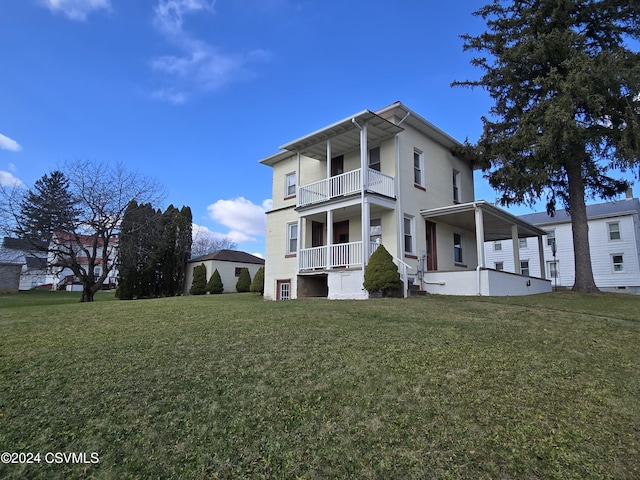 exterior space featuring a porch, a yard, and a balcony