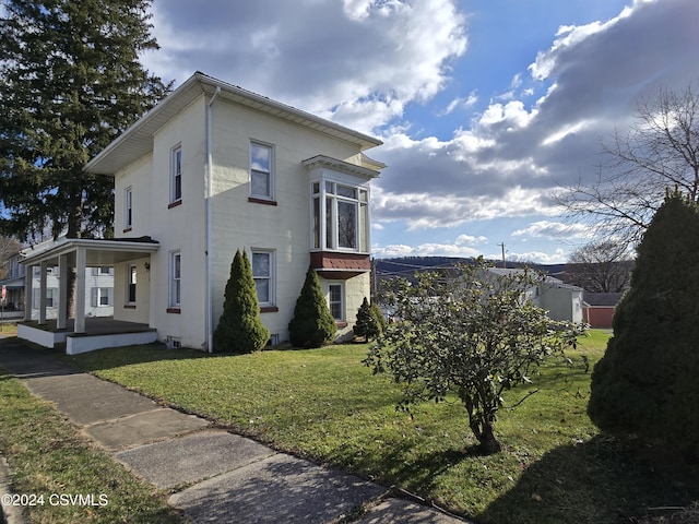 524 Front St, New Berlin, PA 17855 - view of home's exterior with a yard, covered porch, and stucco siding
