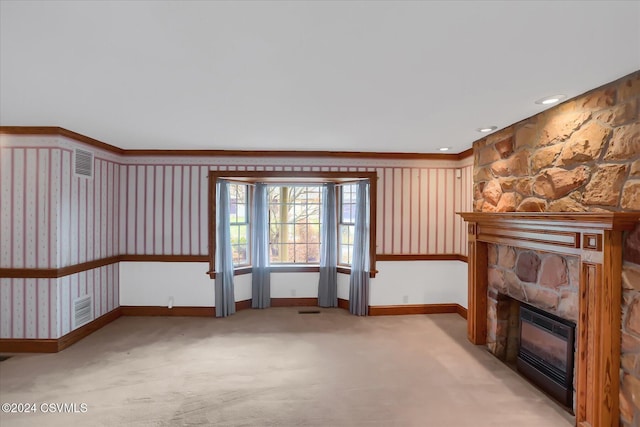 unfurnished living room featuring a fireplace and light carpet