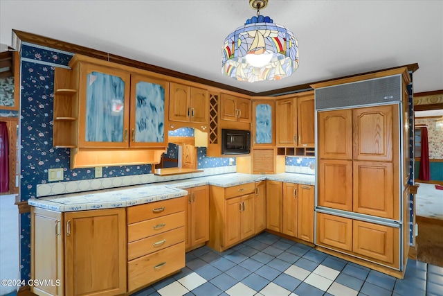 kitchen with light tile patterned floors and decorative light fixtures