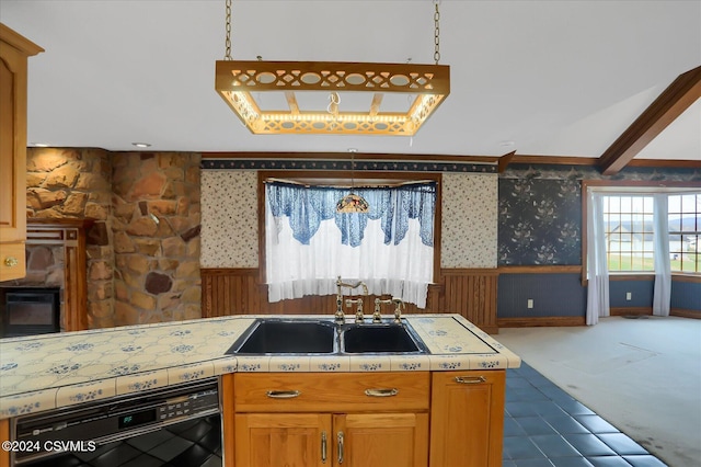 kitchen featuring dishwasher, hanging light fixtures, and sink