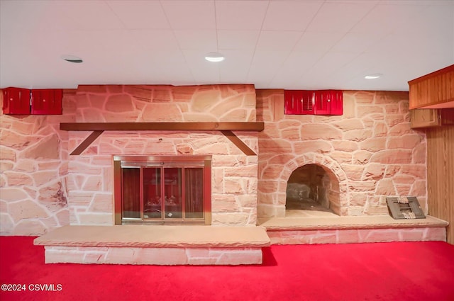 details featuring a stone fireplace and carpet floors