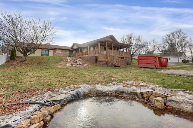 back of house with a lawn and a deck