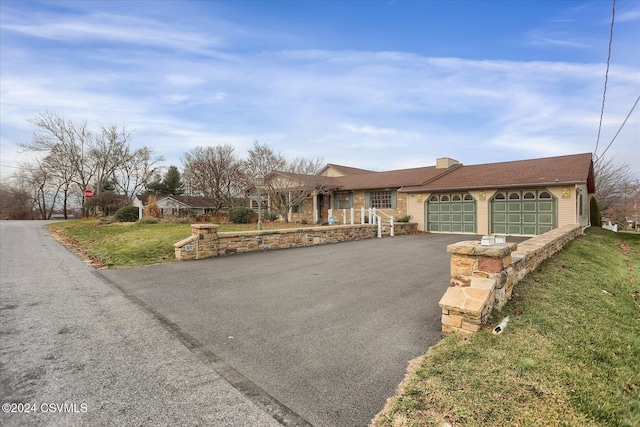 single story home with a front yard and a garage