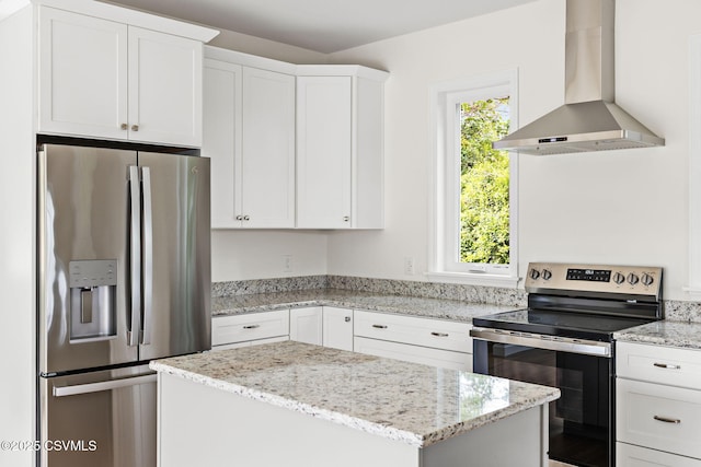151 Hillside Ave, Elysburg, PA 17824 - kitchen featuring appliances with stainless steel finishes, wall chimney range hood, a center island, white cabinets, and light stone counters