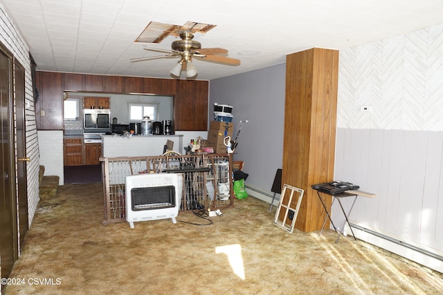 kitchen with carpet flooring, heating unit, a baseboard radiator, and ceiling fan