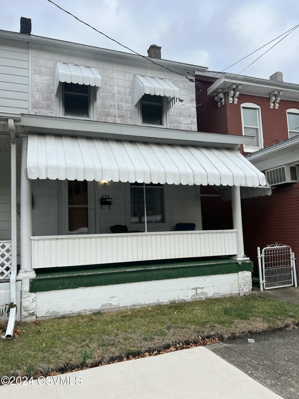 view of side of home featuring a porch