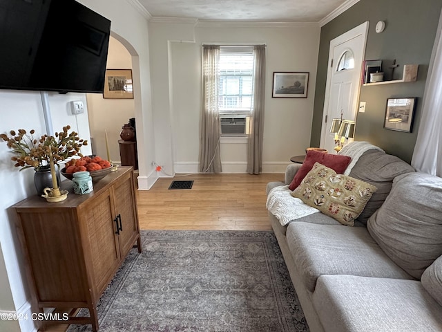 living room featuring light hardwood / wood-style flooring and ornamental molding