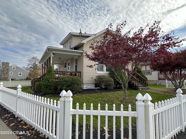 view of property exterior with covered porch and a yard