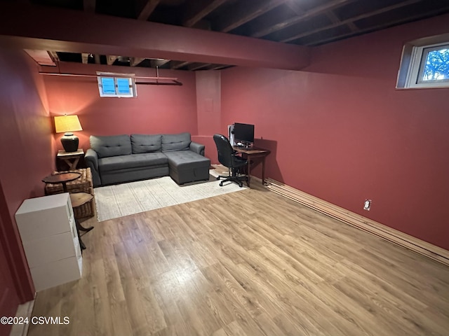 home office with beamed ceiling and light wood-type flooring