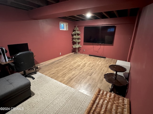 home office with beam ceiling and hardwood / wood-style flooring